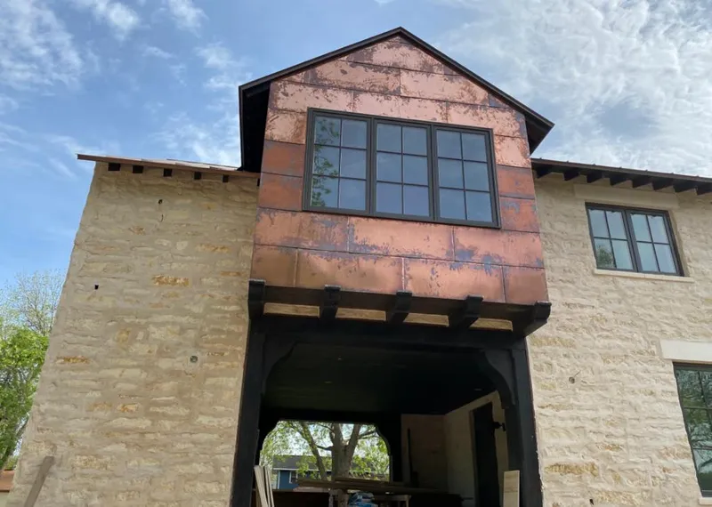 Copper metal panel facade on a stone building for Skylight Installation in Harper Woods