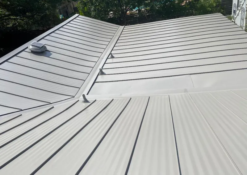 Solar attic fan installed on a metal roof for Roof Ventilation in Harper Woods